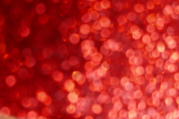 Wallpaper phone shining glitter.Red shiny blurred background. Soft focus.Shining  bokeh surface.Glitter shiny texture.Abstract bright red flickering festive background.