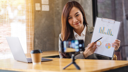 A beautiful young asian businesswoman teaching business class , online meeting concept