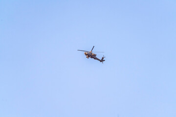 Fototapeta na wymiar Helicopter or chopper flying in a blue sky