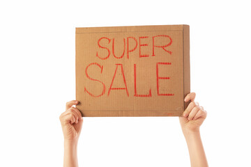 Hands hold a cardboard advertising board on a white background. This is a super sale.