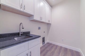White fitted kitchen interior with no appliances