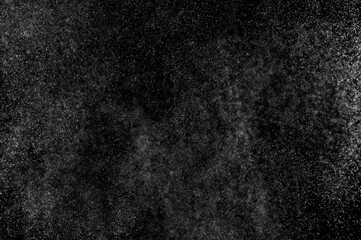 Abstract splashes of water on black background. Freeze motion of white particles. Rain, snow overlay texture.