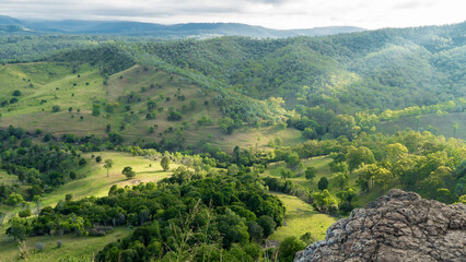 Obraz premium sun rays leaking through clouds in the hills