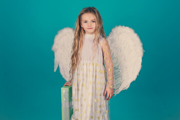 Valentines day. Saint Valentines Day card. Child wearing long white dress and angel wings. Pretty...