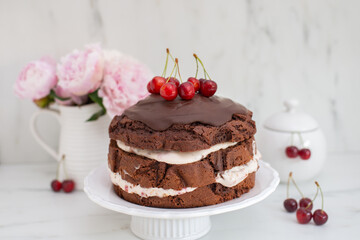 black forest chocolate cake with cherry pie filling with dark chocolate glaze