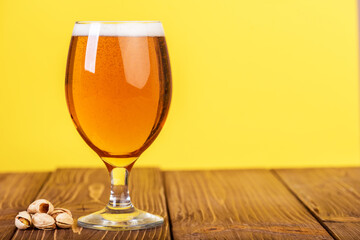 Glass of beer on color background.