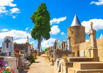 Old cemetery with statues and marble tombstones for the graves in sunny day near the Carcassonne...