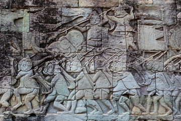 Elephants and marching soldiers of the khmer army carved on a wall of a gallery at Bayon temple at the center of Angkor Thom complex in Siem Reap, Cambodia, South east Asia
