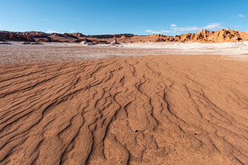 Fototapeta na wymiar A dry riverbed landscape in the arid Moon Valley of the driest desert on earth, Atacama Desert, Chile.