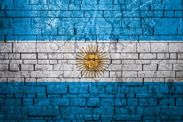 National flag of Argentina on brick  wall background.The concept of national pride and symbol of...