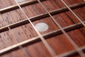 Macro photography to a six electric guitar strings and wooden fretboards. Vintage instruments and...