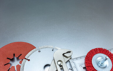 set of abrasive tools with studded diamond blade on grey metal background 
