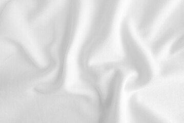 Fototapeta premium White abstract folded clothes background, fabric texture
