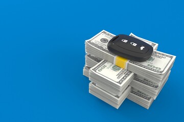 Car remote key on stack of money