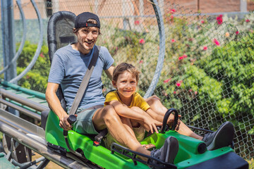 Father and son on the alpine coaster