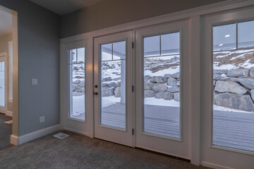 Looking out through glass windows at snow