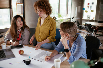 Businesswomen working on a new project. Colleagues discussing about problem they have to solved.