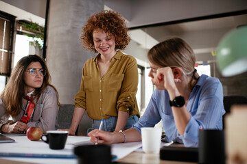 Businesswomen working on a new project. Colleagues discussing about problem they have to solved.