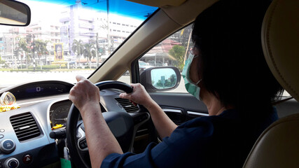 woman driving a car wearing the mask, New normal life for a day concept.