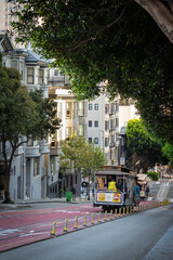 Tourists and local people ride Cable Car Trolley going down hill middle of the street. Fun...