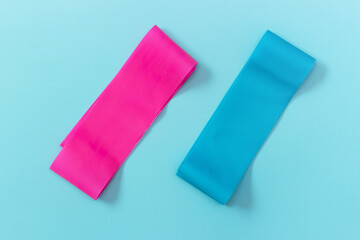 Elastic expanders on blue background view from above, copy space