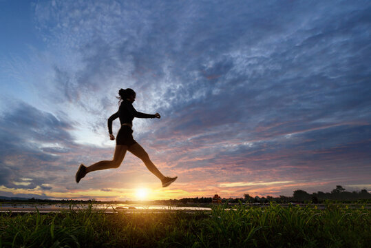 Woman runner warmup on outdoor,Sport People Running on during sunset,moveing photo