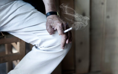 Cigarette damage caused by nicotine-addicted old man