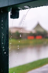 Blurred natural rainy background with water drops in motion. Heavy rain pouring from the roof