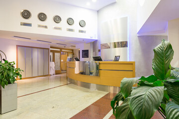 Interior of a hotel reception area with wooden reception desk