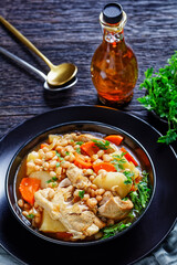 white bean, vegetables pork stew in a bowl