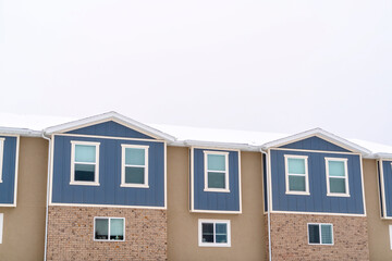 Townhome exterior with sliding glass windows brick walls and vertical sidings