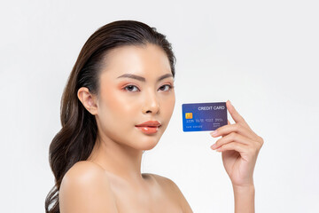 Youthful skin Asian woman showing credit card isolated on white background for beauty treatment promotion and installment payment concepts