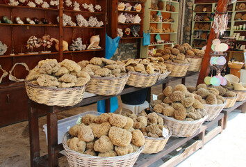 Sea sponges of different shapes and sizes sold at a small shop in Symi town, Symi island, Greece
