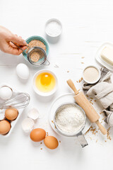 Baking homemade bread on white kitchen worktop with ingredients for cooking, culinary background, copy space, overhead view