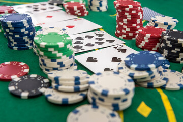 many poker chips with play card on casino table