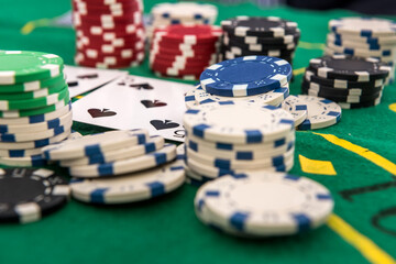 many poker chips with play card on casino table