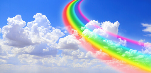 White clouds in the blue sky and colourful rainbow