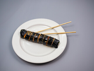 Gimbap (Korean Seaweed Rice Rolls) - with chop sticks,  focus on top rolls