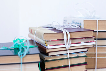 stacks of old books bound with twine for carrying