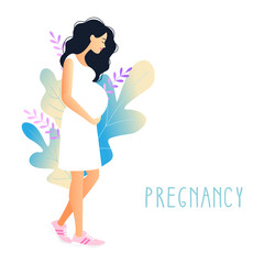 beautiful pregnant woman with hand on her stomach on a background of foliage. young woman stroking belly. Pregnancy.