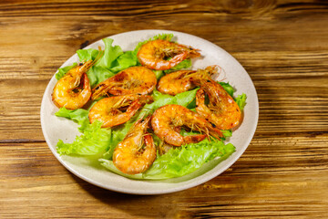 Fototapeta na wymiar Tasty baked shrimps on a wooden table