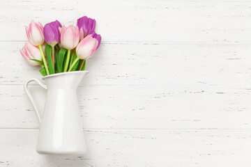 Pink tulips over wooden background