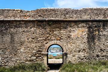 A wall with a gate overlooking the sea
