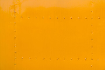 yellow metal wall. yellow steel plate with rivet background and texture.