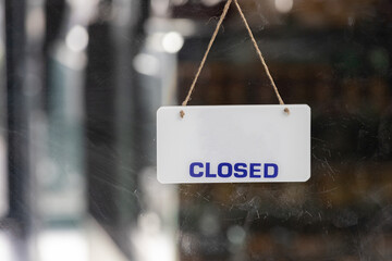 close sign hanging on glass door of shop.