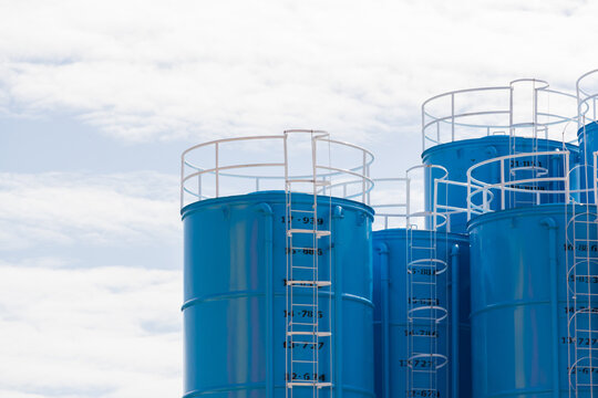 blue steel silos on cloudy sky. metal container for concrete mix process plant.