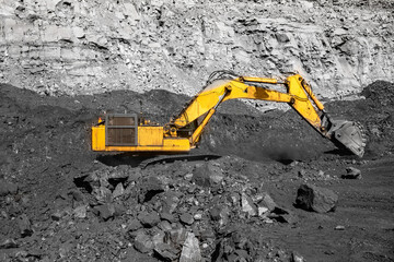 Open pit mine industry work of large yellow excavator for loading and coal mining