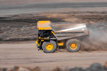 Big yellow mining empty truck with dust transportation. Open pit mine industry