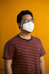 Covid-19 Coronvavirus.Working from home concept.Asian man wearing face mask. Pandemic virus symptoms.