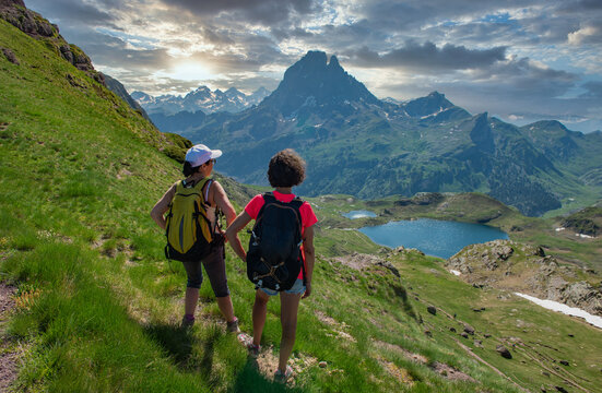 two hiker women in path of Pic du Midi Ossau in french Pyrenees mountains